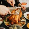 A Person Slicing Roasted Chicken