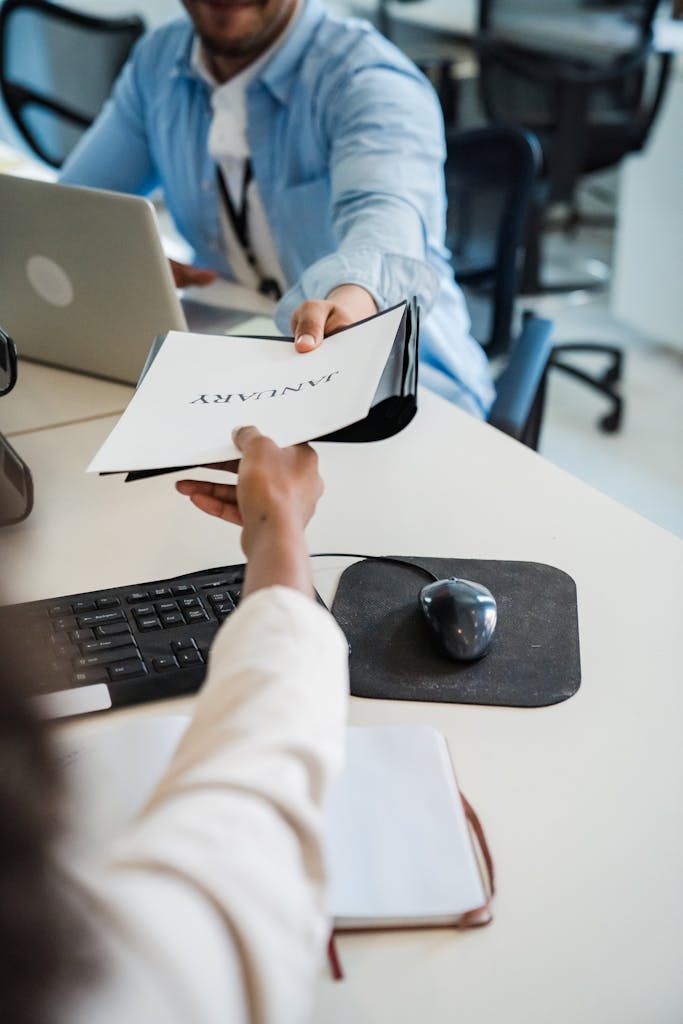 Office Workers Passing on Documents in an Office